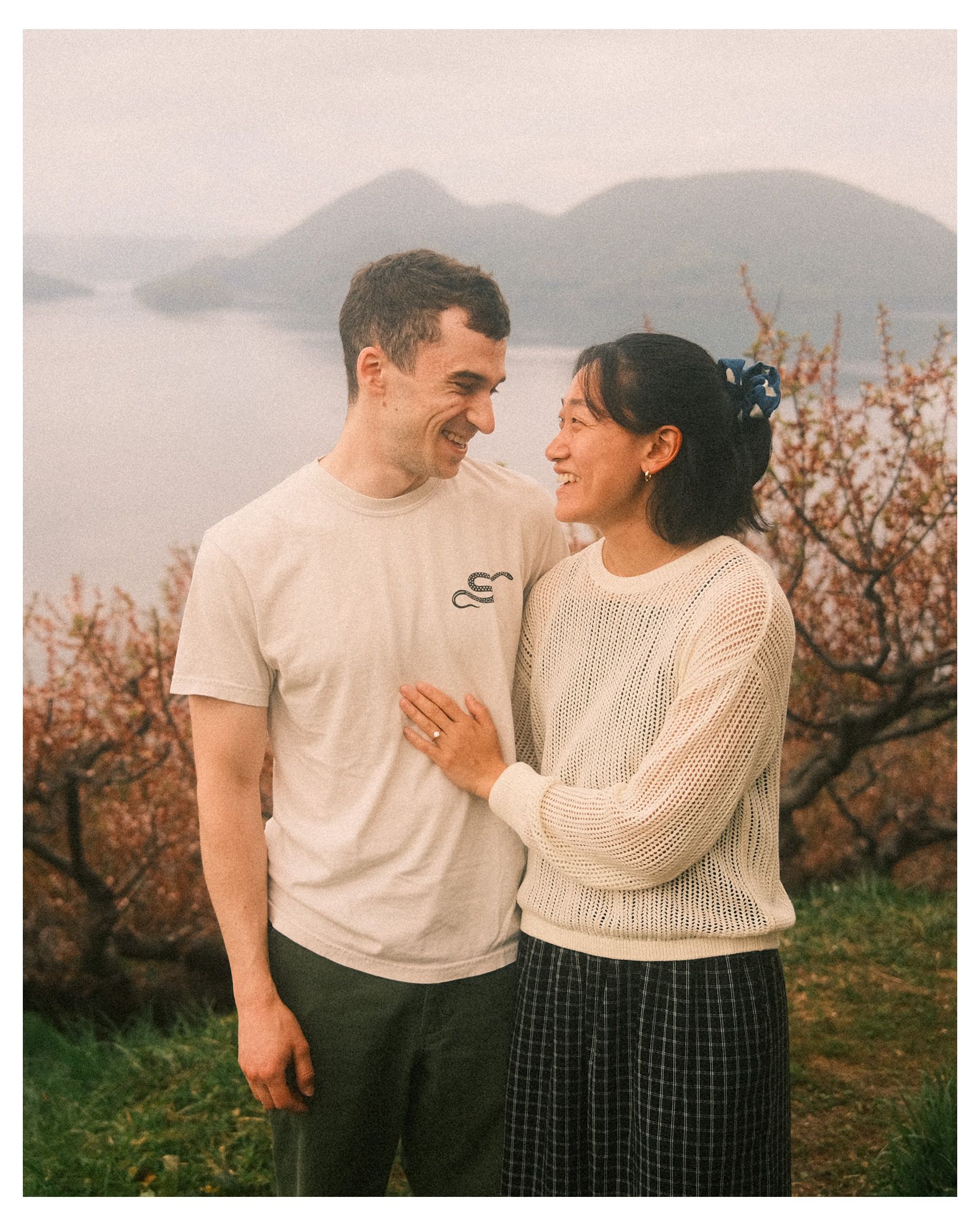 Tracey and Nick smiling at each other outdoors